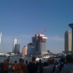 Het publiek stroomt massaal toe terwijl twee helikopters manoeuvres uitvoeren boven de Nieuwe Maas.